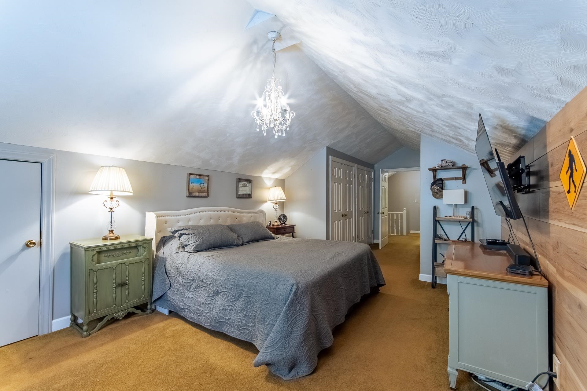 4083 57th Highway West Ramer, TN 38367 - Photo 22 of 40 a bedroom with a large bed and a chandelier