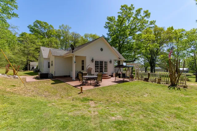a view of a house with backyard porch and sitting area