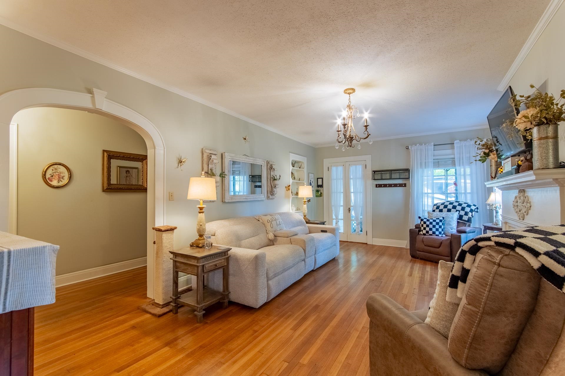 4083 57th Highway West Ramer, TN 38367 - Photo 5 of 40 a living room with furniture a chandelier and a fireplace