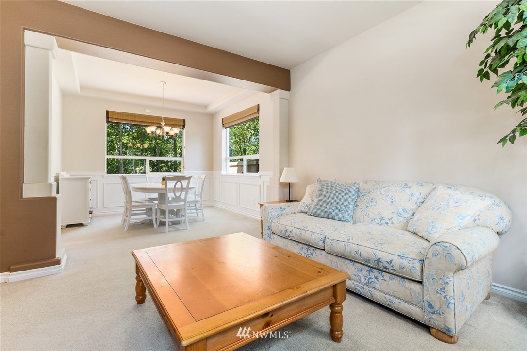 16008 Sunset Road Bothell, WA 98012 - Photo 11 of 28 a living room with furniture a large window and potted plants