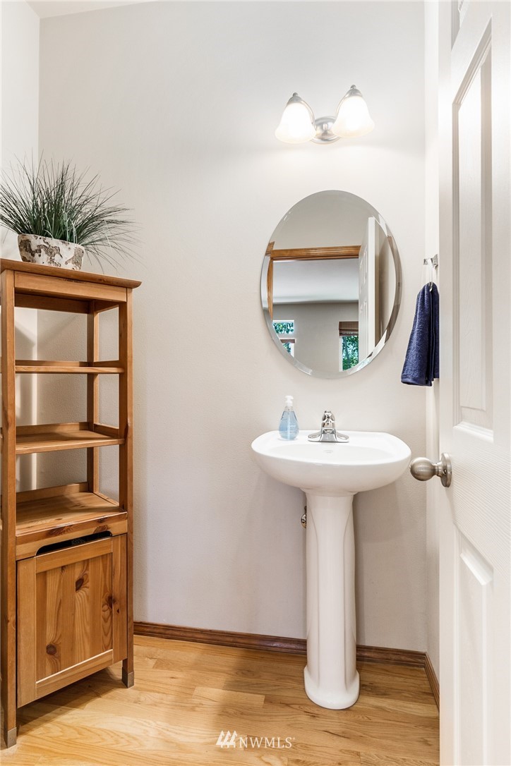 16008 Sunset Road Bothell, WA 98012 - Photo 13 of 28 a bathroom with a sink a mirror and vanity