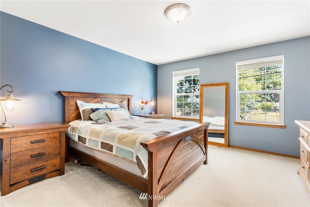 16008 Sunset Road Bothell, WA 98012 - Photo 14 of 28 a bed room with a bed and a window