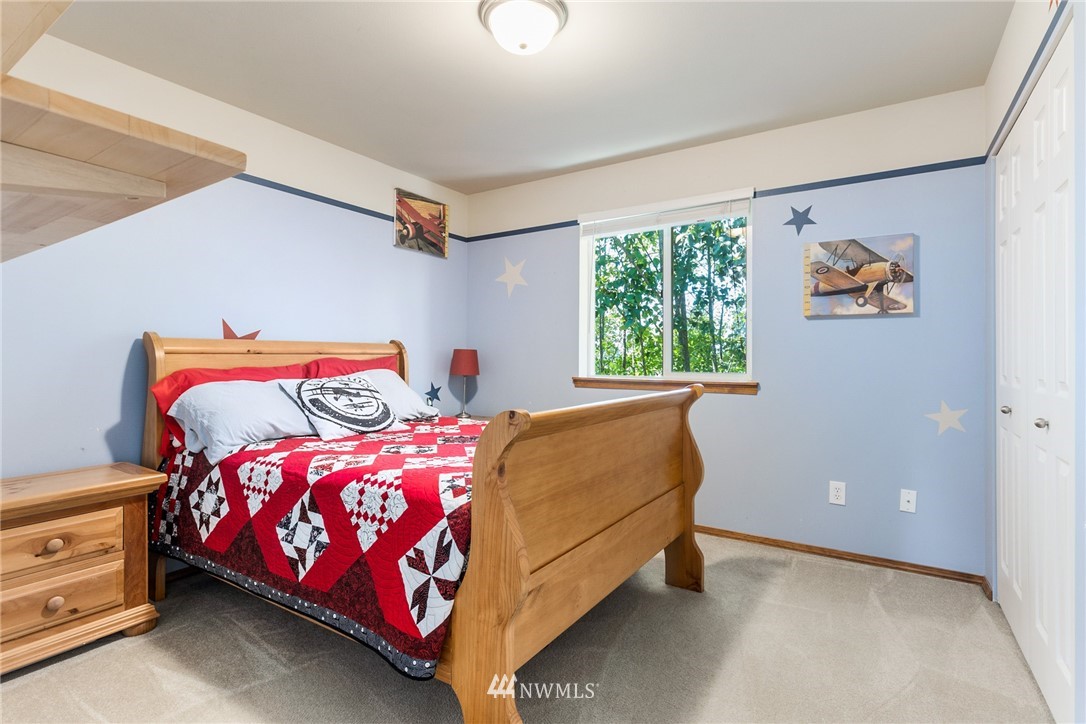 16008 Sunset Road Bothell, WA 98012 - Photo 20 of 28 a bedroom with a bed and a window