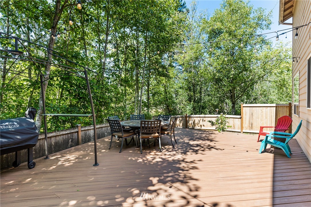 16008 Sunset Road Bothell, WA 98012 - Photo 27 of 28 a view of a patio with a dining table and chairs with wooden floor
