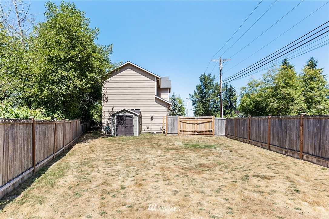 16008 Sunset Road Bothell, WA 98012 - Photo 28 of 28 a view of backyard with small cabin and wooden fence