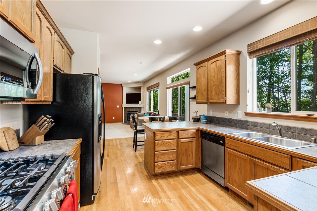 16008 Sunset Road Bothell, WA 98012 - Photo 8 of 28 a kitchen with stainless steel appliances granite countertop a stove and a sink