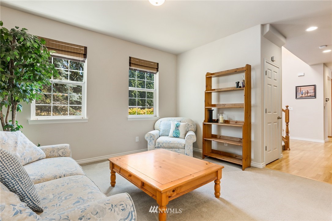 16008 Sunset Road Bothell, WA 98012 - Photo 10 of 28 a living room with furniture a window and a flat screen tv