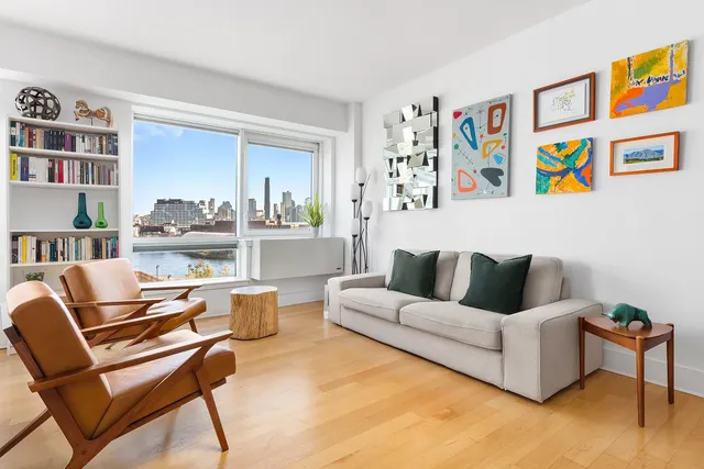 a living room with furniture and a book shelf