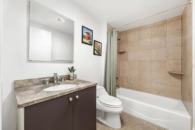 a bedroom with a bed and a large window with the outer view