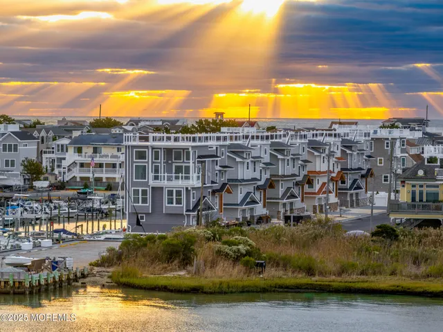 a view of a lake with a building and trees in the background