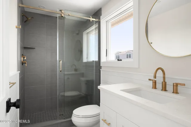 a bathroom with a sink toilet and shower