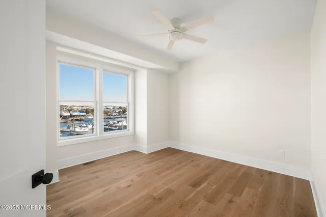 a view of a lake with a building and trees in the background
