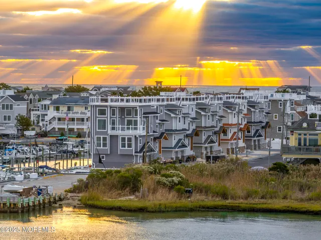 a view of residential houses with swimming pool and lake view