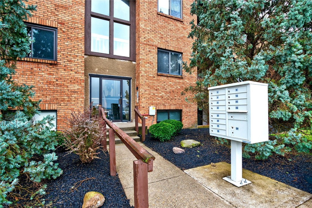 This brick exterior features a private entrance and well-maintained landscaping.