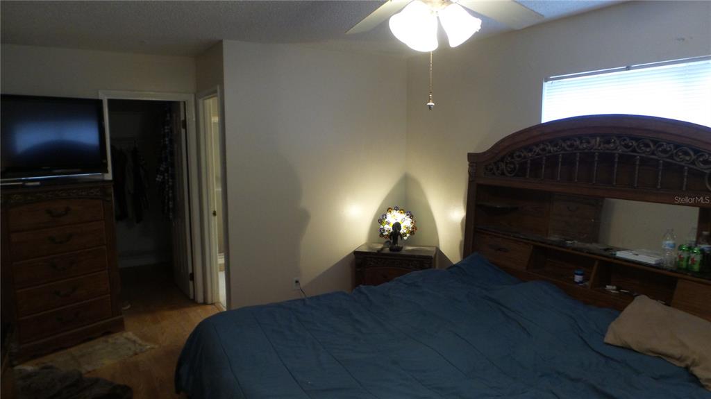 10127 Fox Squirrel Drive New Port Richey, FL 34654 - Photo 12 of 18 a bedroom with a bed and a fireplace