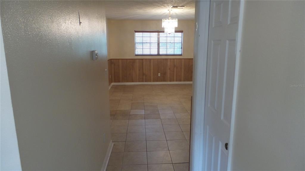10127 Fox Squirrel Drive New Port Richey, FL 34654 - Photo 13 of 18 a view of an empty room with wooden floor and a window