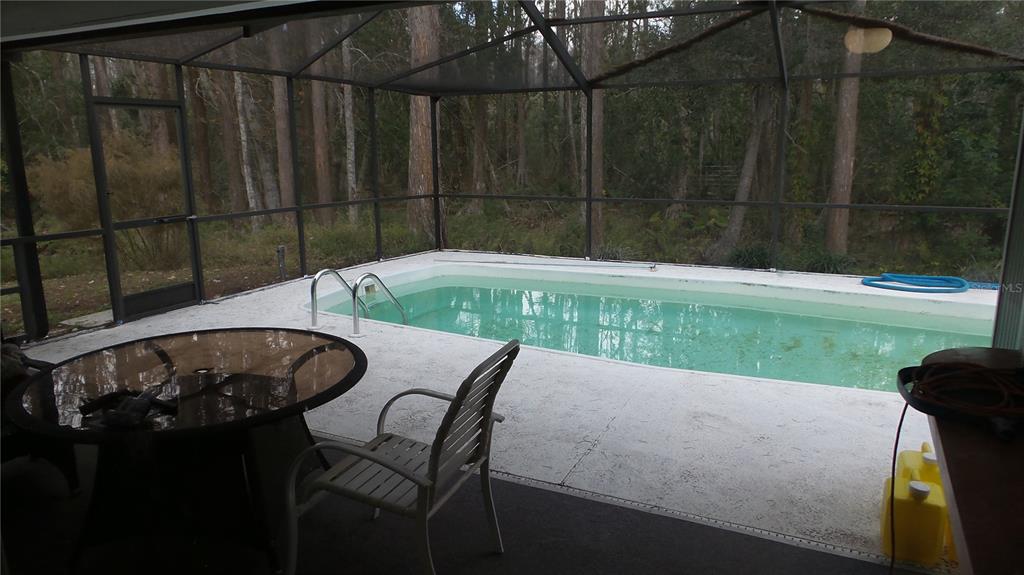 10127 Fox Squirrel Drive New Port Richey, FL 34654 - Photo 15 of 18 a backyard of a house with table and chairs