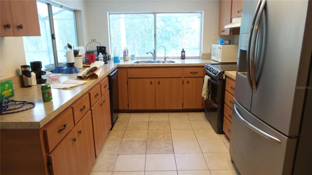 10127 Fox Squirrel Drive New Port Richey, FL 34654 - Photo 7 of 18 a kitchen with appliances cabinets and a sink