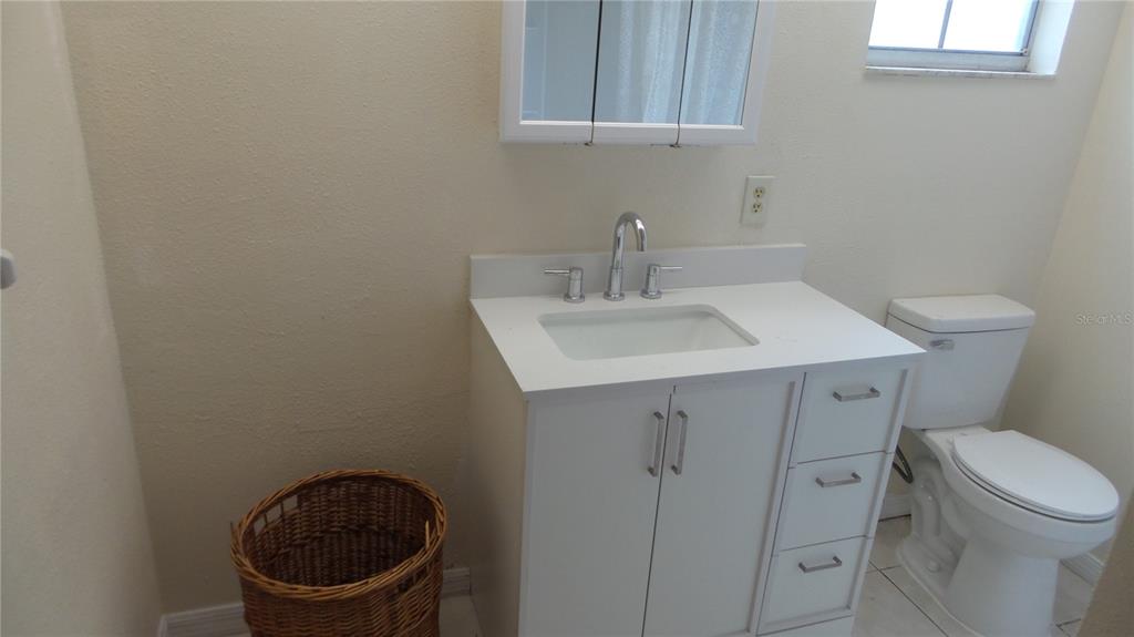 10127 Fox Squirrel Drive New Port Richey, FL 34654 - Photo 8 of 18 a bathroom with a toilet a sink and a window