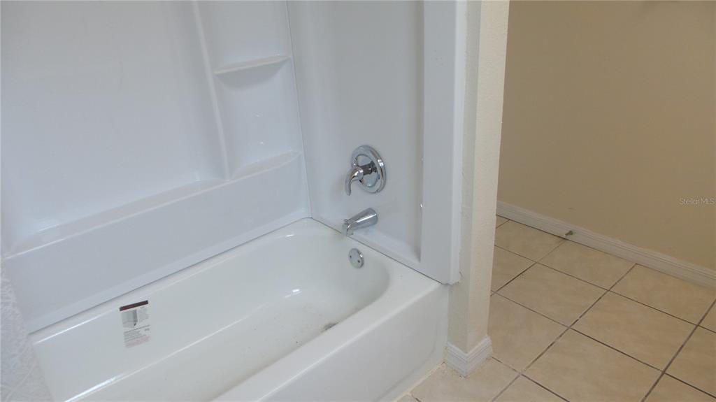 10127 Fox Squirrel Drive New Port Richey, FL 34654 - Photo 9 of 18 a bathroom with a bathtub