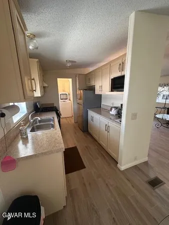 a kitchen with a sink and a stove top oven