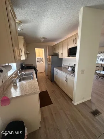 a kitchen with a sink and a stove top oven