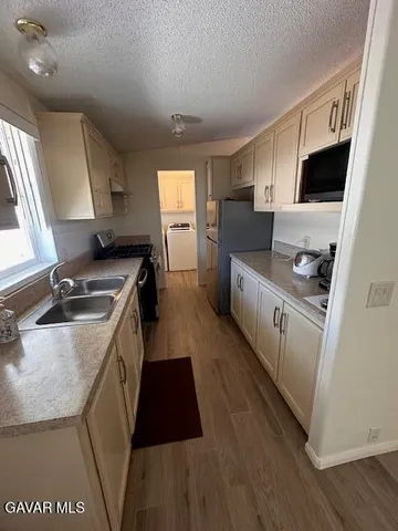 a kitchen with a sink a stove a refrigerator and a sink