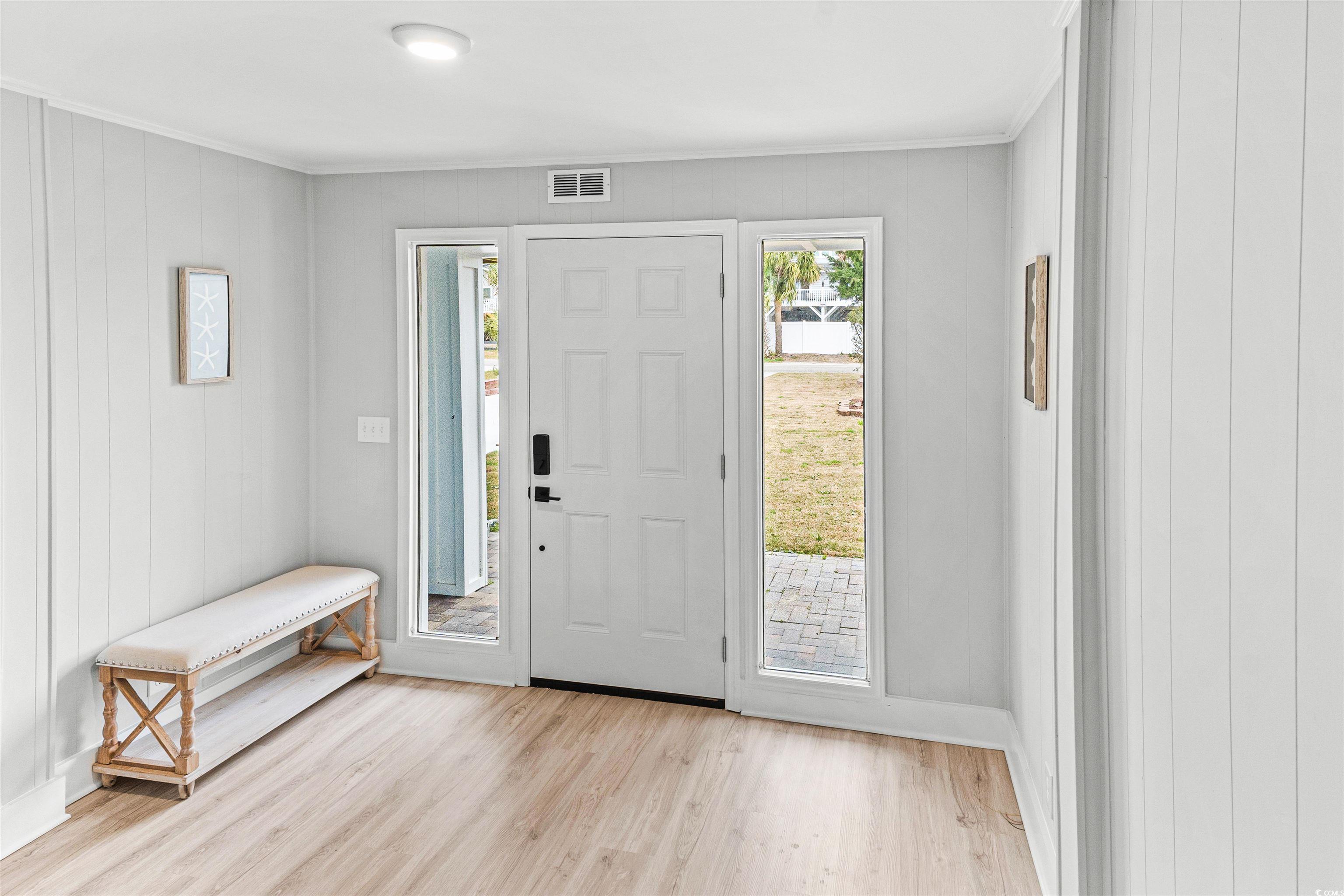 338 State Rd S-26-530 Murrells Inlet, SC 29576 - Photo 4 of 39 Foyer entrance featuring baseboards, ornamental molding, visible vents, and wood finished floors