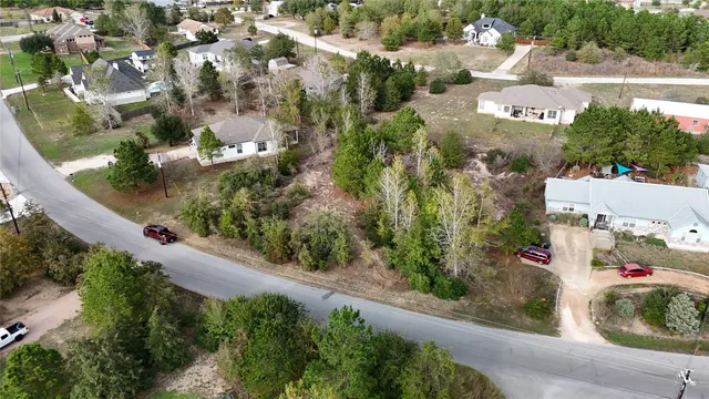 an aerial view of residential houses with green space