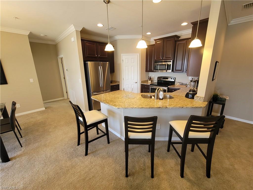 8561 Violeta Street, Unit 202 Estero, FL 34135 - Photo 11 of 40 a view of a dining room with furniture