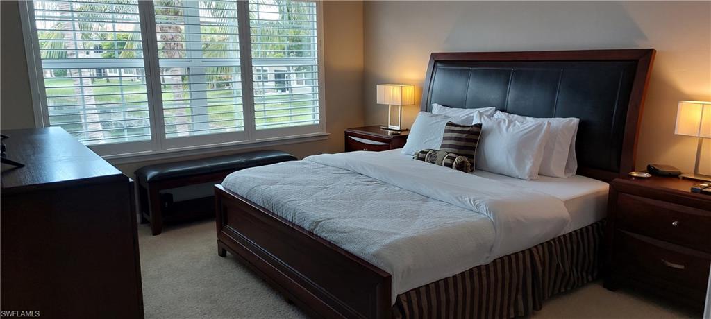8561 Violeta Street, Unit 202 Estero, FL 34135 - Photo 15 of 40 a bedroom with a bed and a window