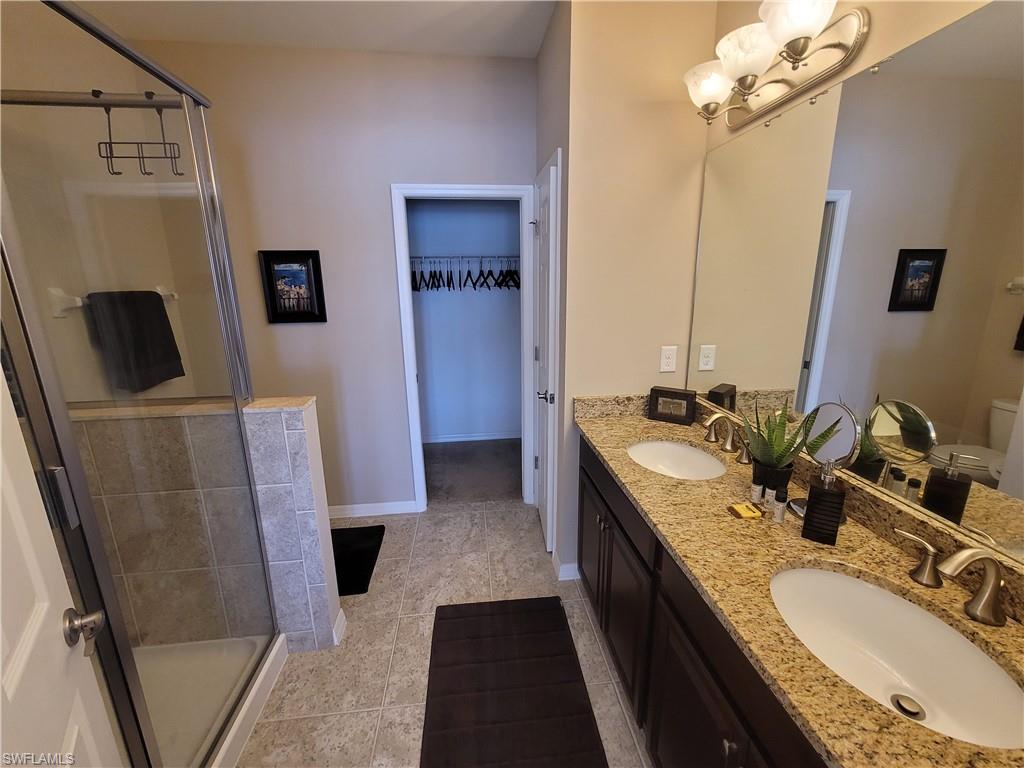8561 Violeta Street, Unit 202 Estero, FL 34135 - Photo 19 of 40 a bathroom with double vanity and a mirror