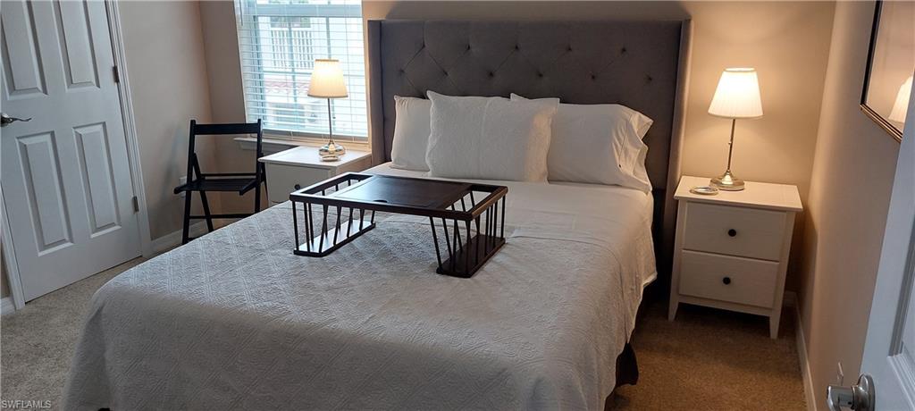 8561 Violeta Street, Unit 202 Estero, FL 34135 - Photo 20 of 40 a bedroom with bed and window