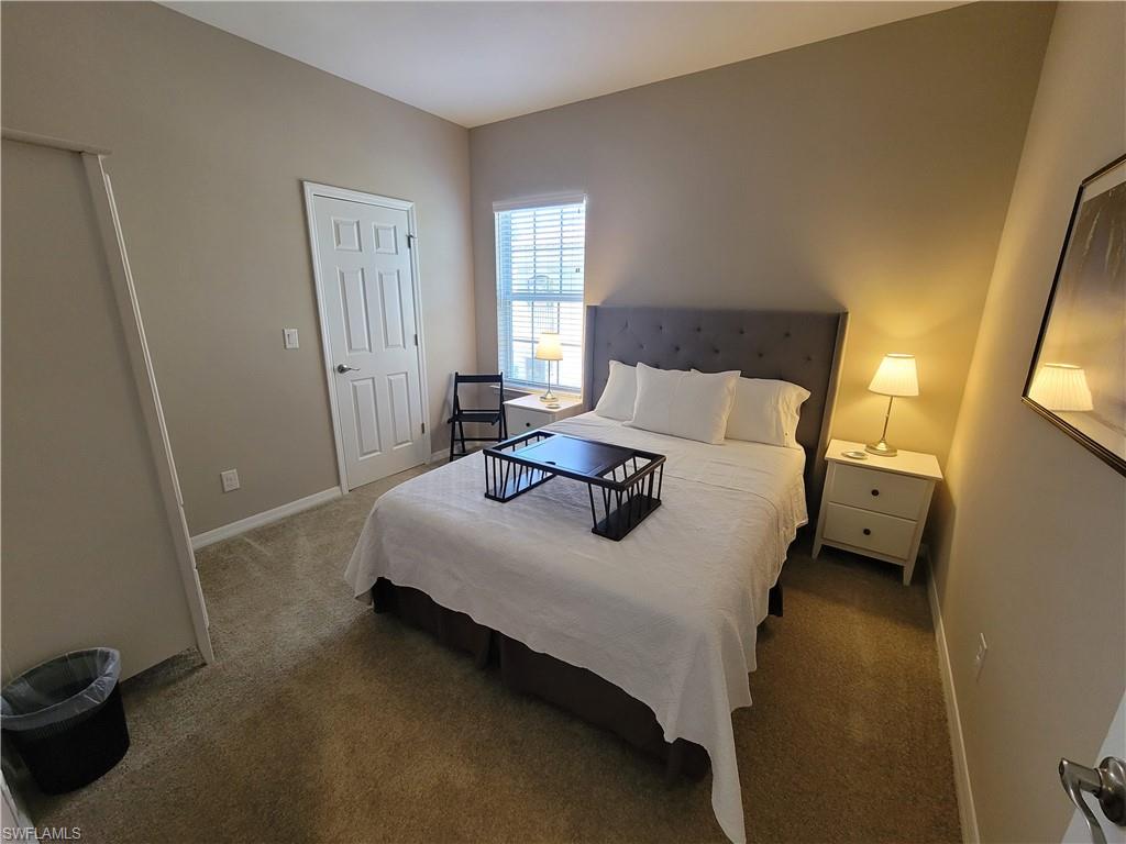 8561 Violeta Street, Unit 202 Estero, FL 34135 - Photo 21 of 40 a bedroom with a bed and window