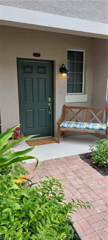 8561 Violeta Street, Unit 202 Estero, FL 34135 - Photo 27 of 40 a front view of a house with a yard