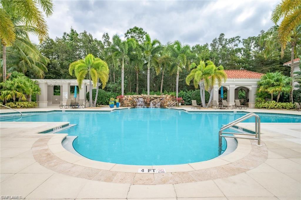 8561 Violeta Street, Unit 202 Estero, FL 34135 - Photo 30 of 40 a view of a swimming pool with a garden