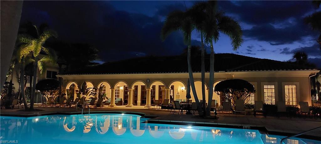 8561 Violeta Street, Unit 202 Estero, FL 34135 - Photo 33 of 40 a front view of a house with swimming pool and porch