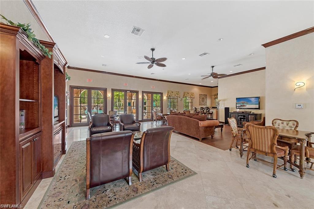 8561 Violeta Street, Unit 202 Estero, FL 34135 - Photo 37 of 40 a living room with furniture a flat screen tv and a large window