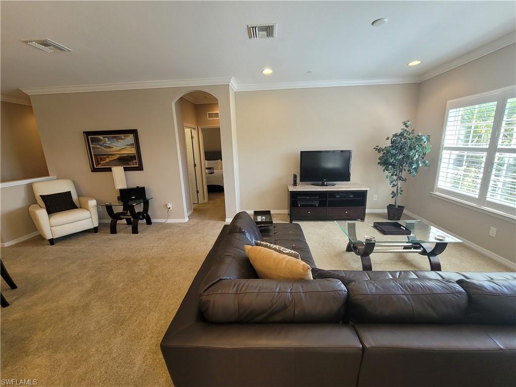 8561 Violeta Street, Unit 202 Estero, FL 34135 - Photo 5 of 40 a living room with furniture and a flat screen tv