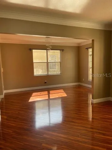 a room with wooden floor and a window