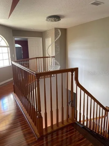a view of staircase with wooden floor