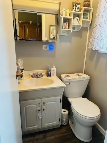 a bathroom with a toilet sink and mirror
