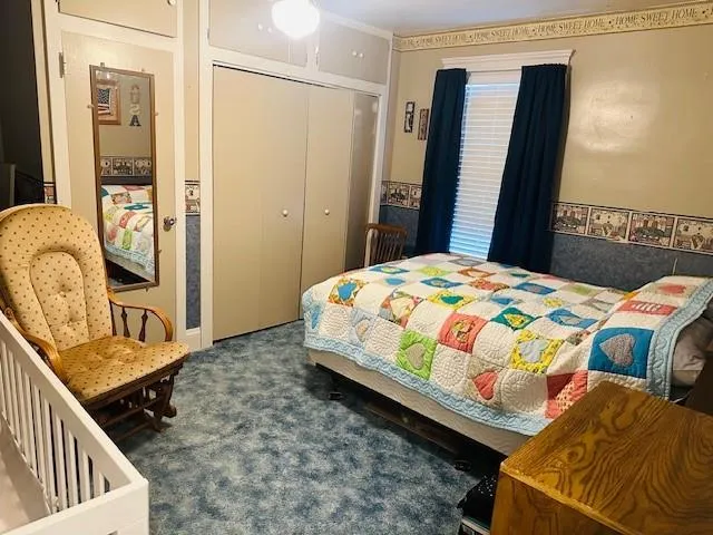 a bedroom with a bed and a dresser in it