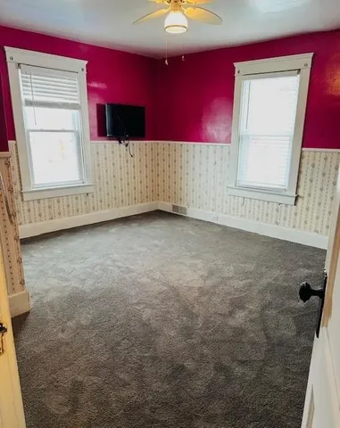 a view of a livingroom with an empty space and a window