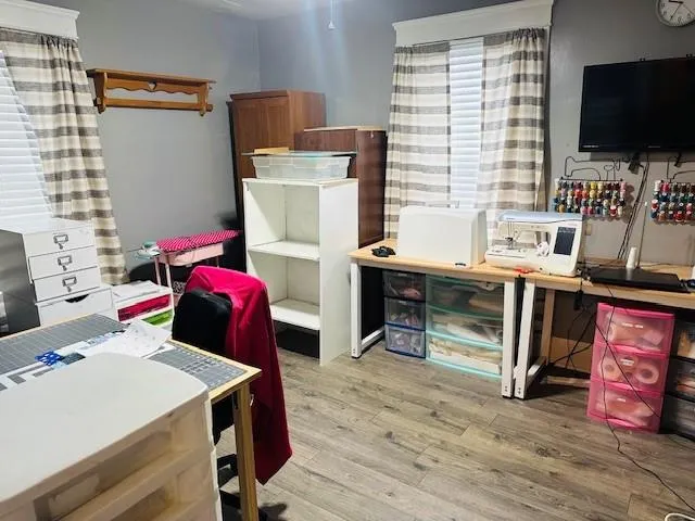 a kitchen with a stove a refrigerator and a dining table with wooden floor