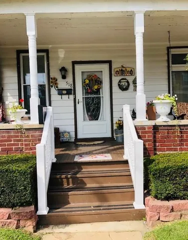 a front view of a house with potted plants
