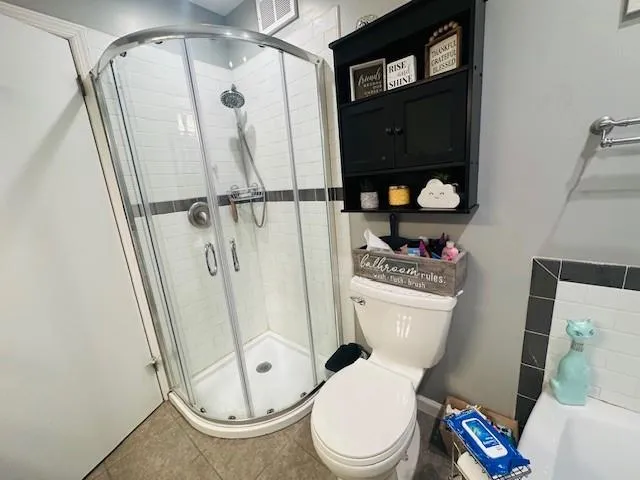 a bathroom with a toilet and a shower