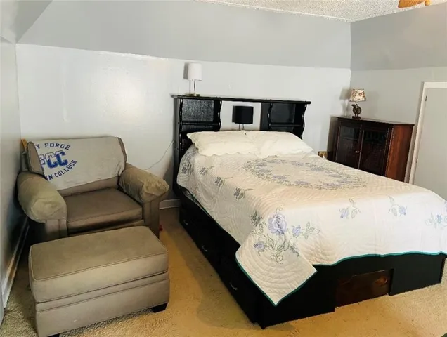 a bed sitting in a bedroom next to a window