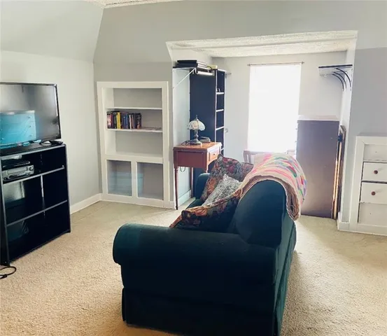 a bedroom with a bed and a television