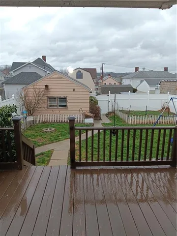 a view of a deck with wooden floor and city view